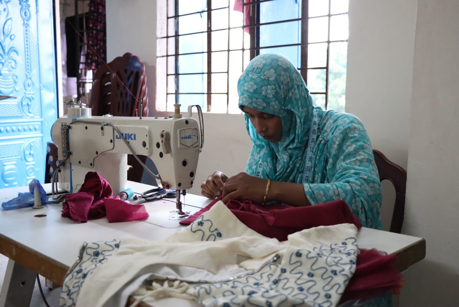 Monira at her sewing machine