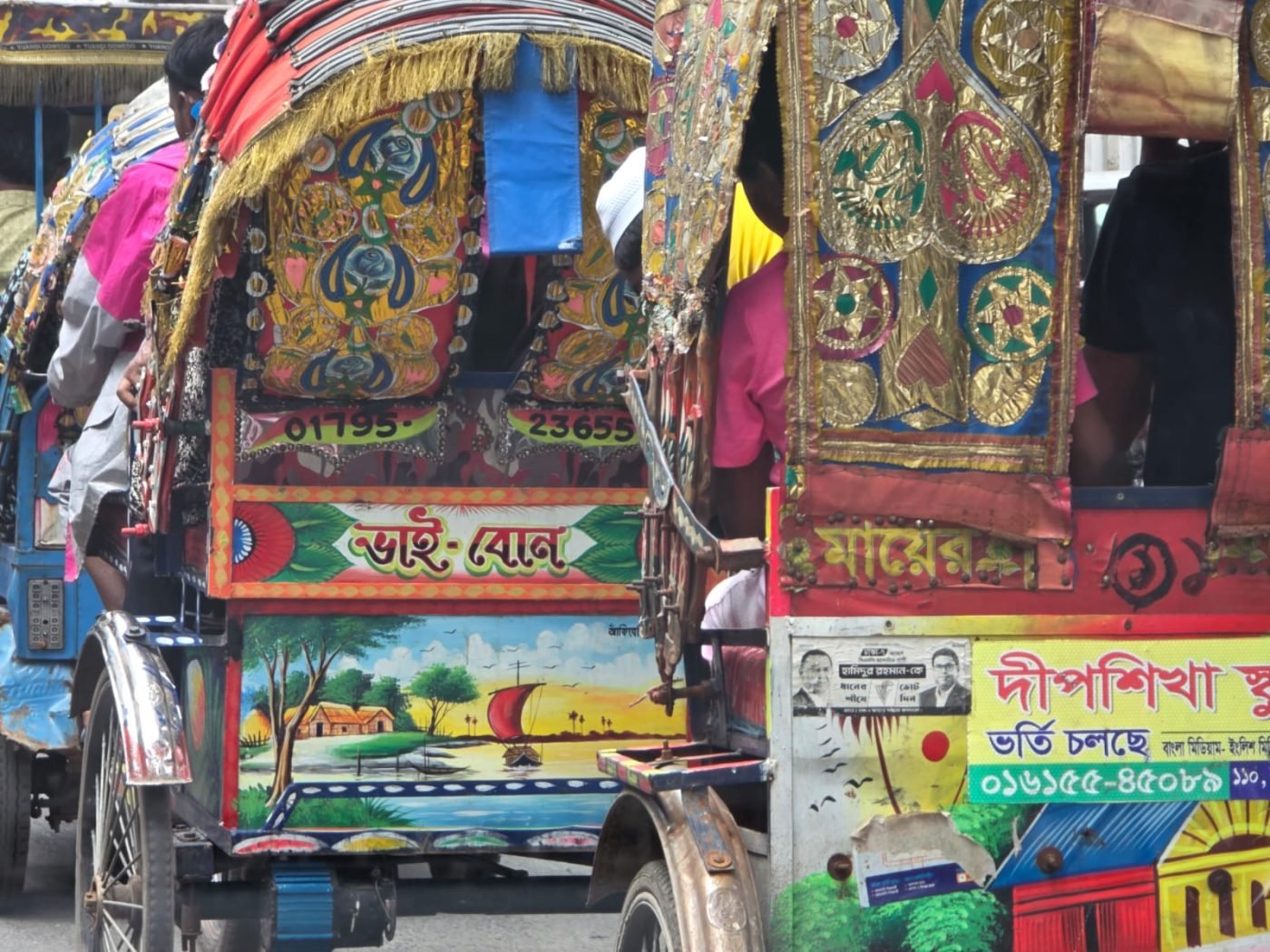 Hand-painted rickshaw panels in Dhaka traffic — gold foil work above a painted river landscape